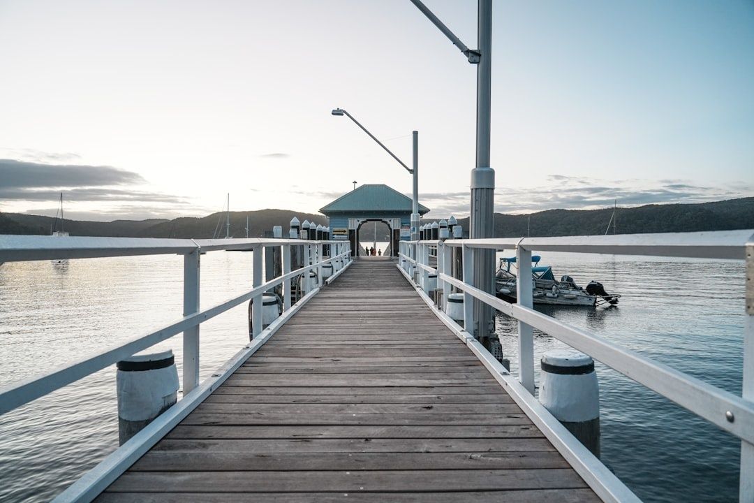 Wooden public jetty leading to a covered waterfront pavilion